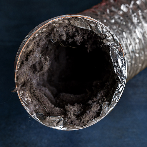 A dirty laundry flexible aluminum dryer vent duct ductwork filled with lint, dust and dirt against a blue background Dryer Vent Cleaning Summerville SC